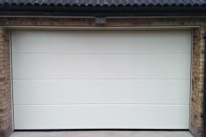 White sectional garage door, insulated easy opening. Manufactured & installed by Bulldog Garage Doors